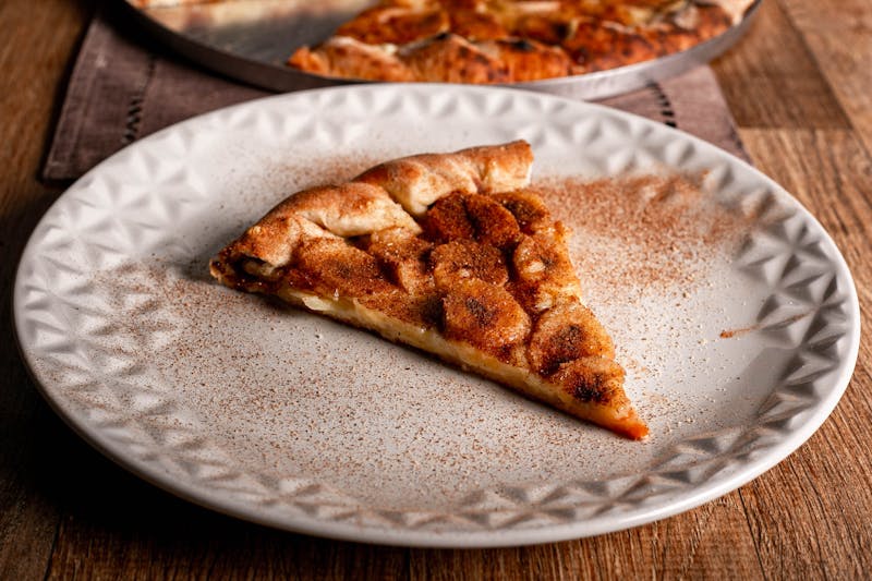 Cinnamon dessert pizza with cream cheese drizzle